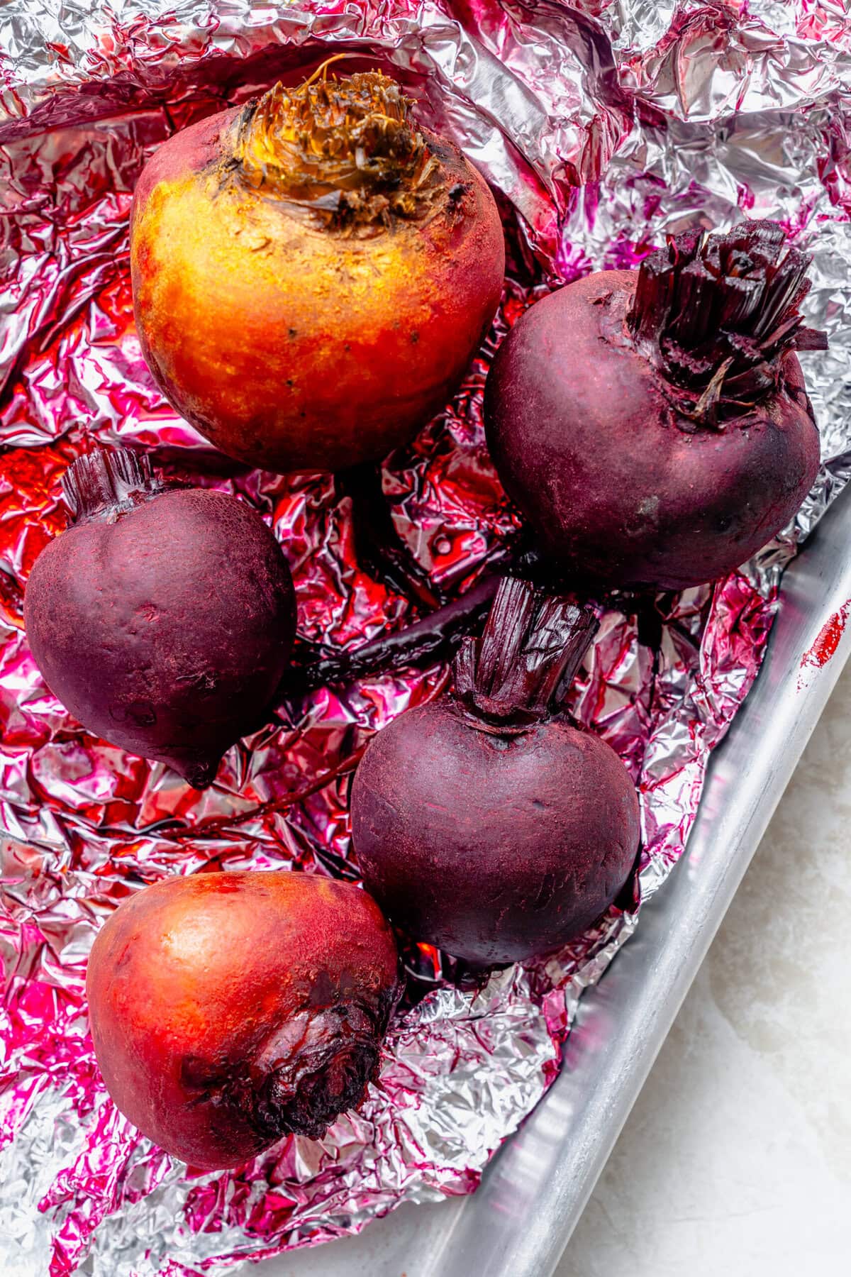 Roasted beets on a piece of foil.