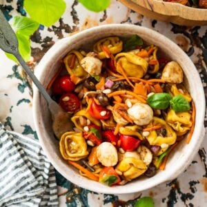 bowl of Italian tortellini pasta salad with a fork.