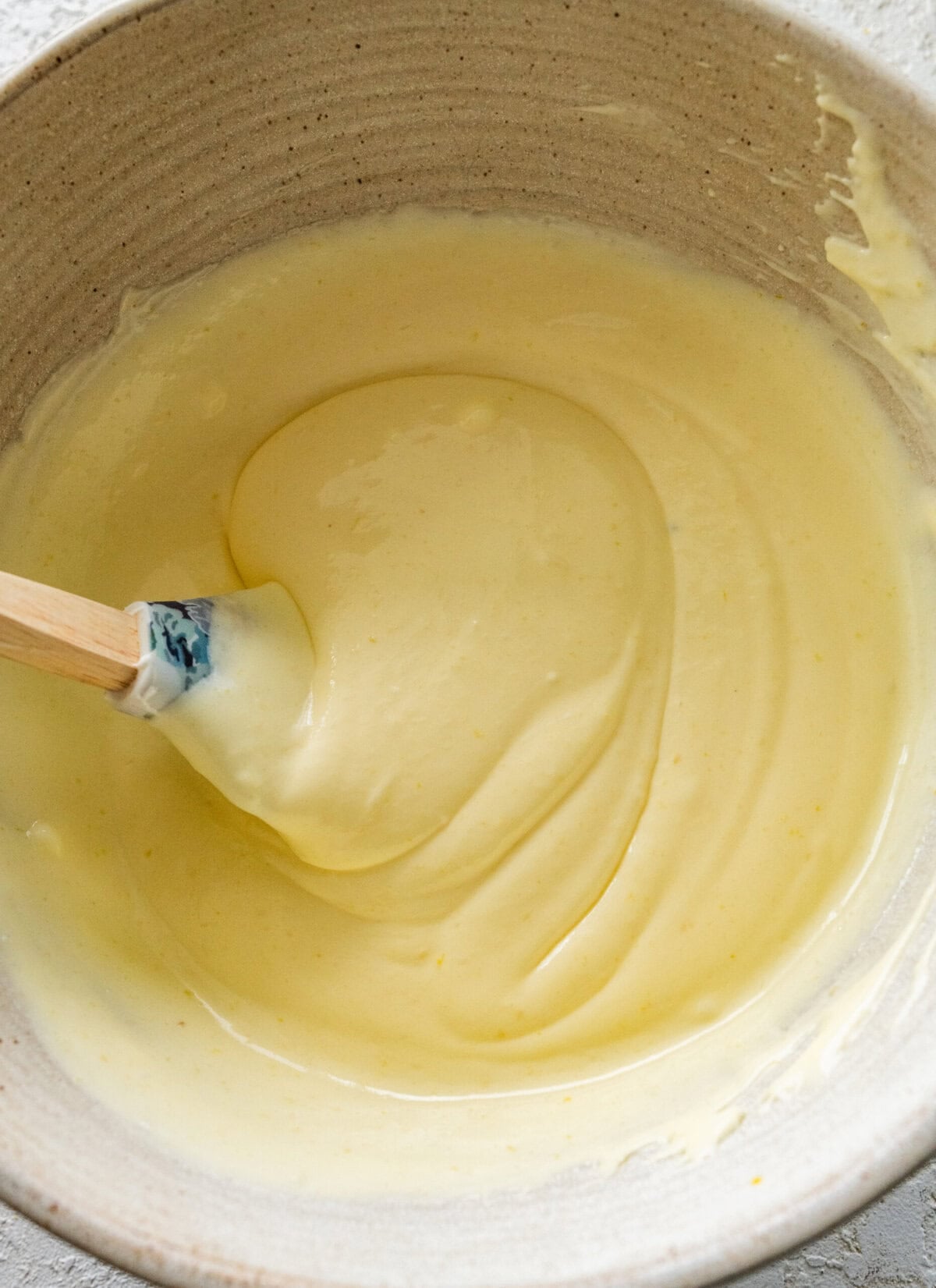 A bowl of fully combined lemon mousse.