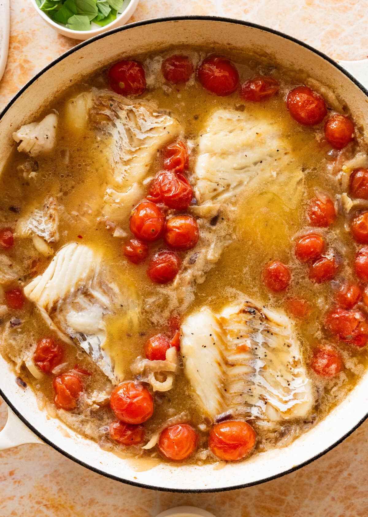 Water, cherry tomatoes, and salt added to the skillet.