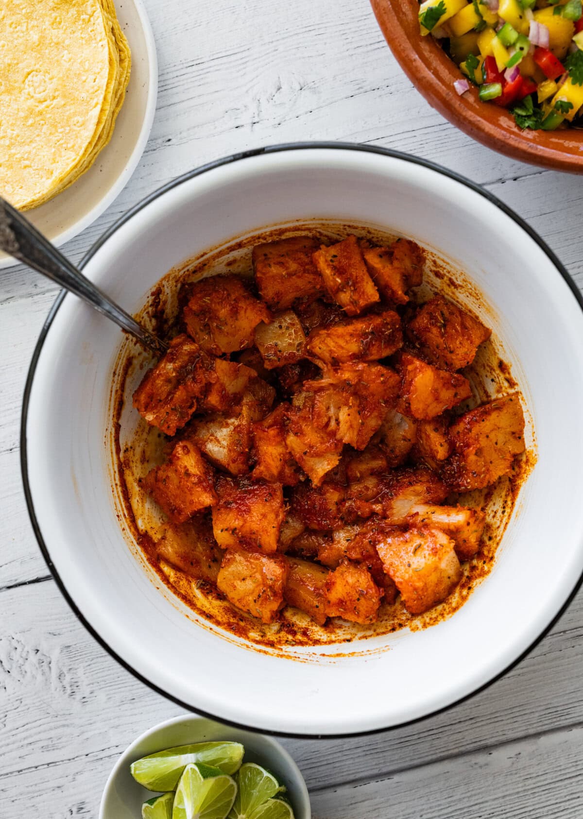 cod in a bowl mixed with the seasoning.