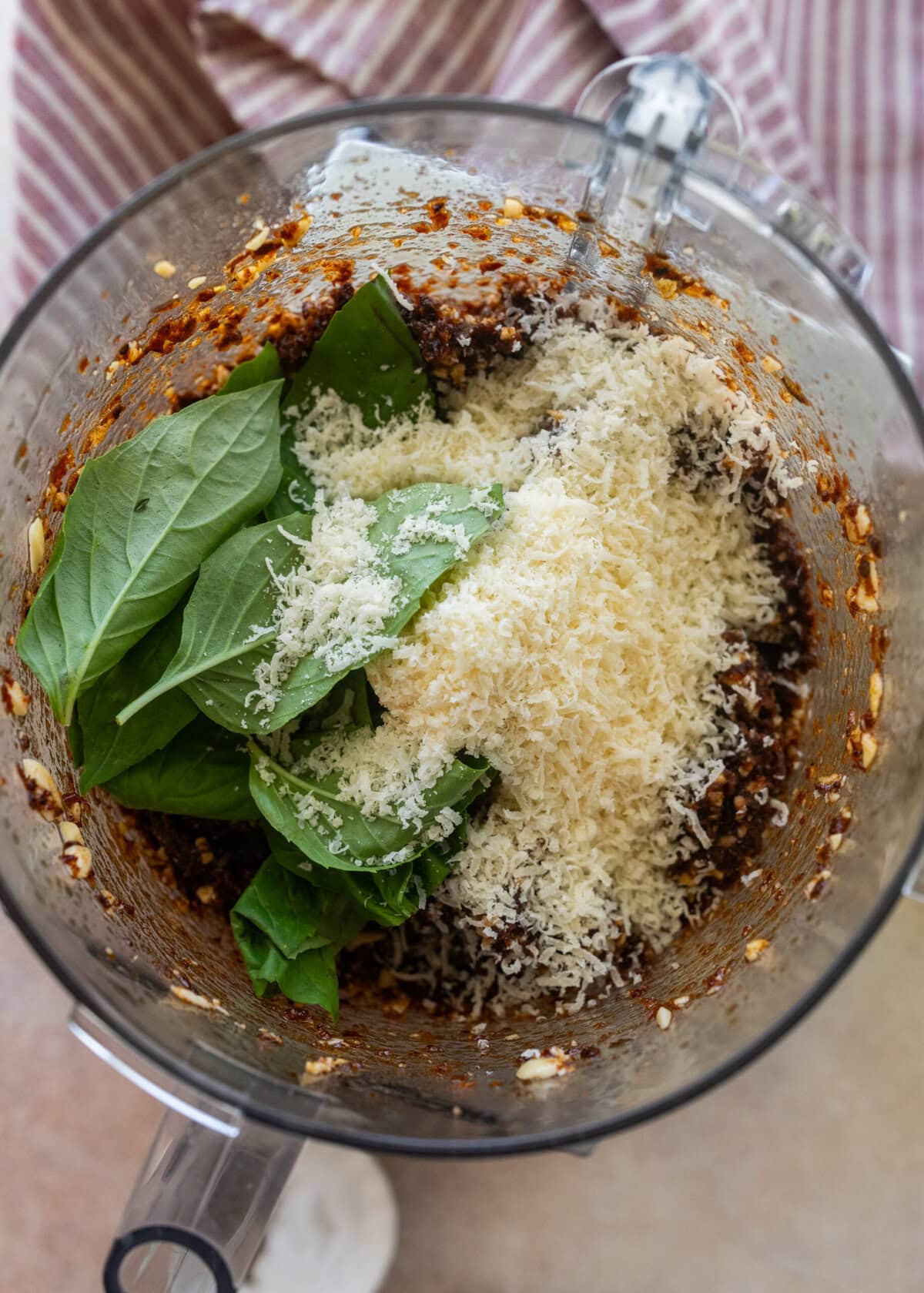 Herbs and cheese added to the food processor.