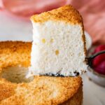 holding a slice of angel food cake on a cake lifter.