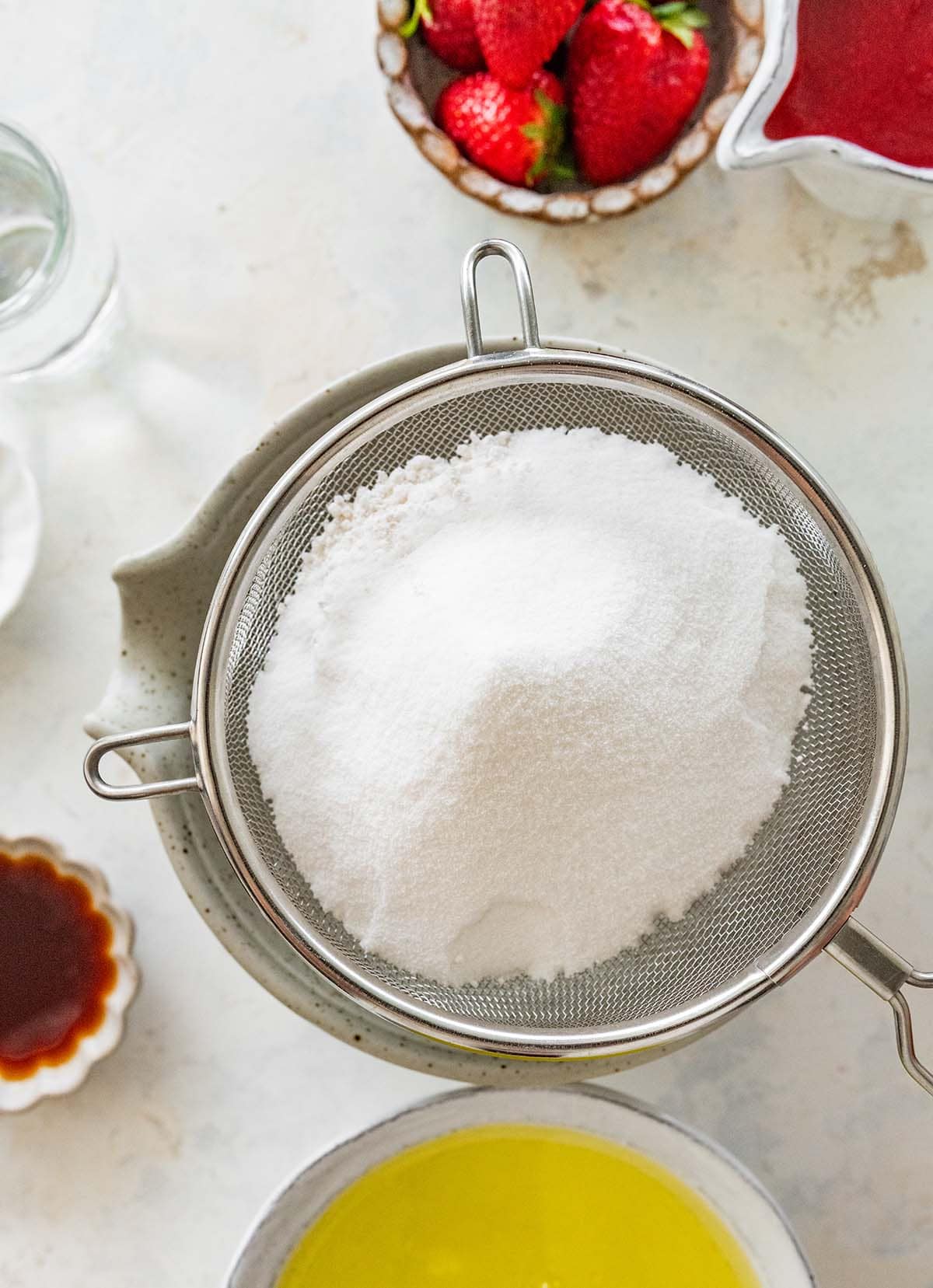 sifting dry ingredients into a bowl.