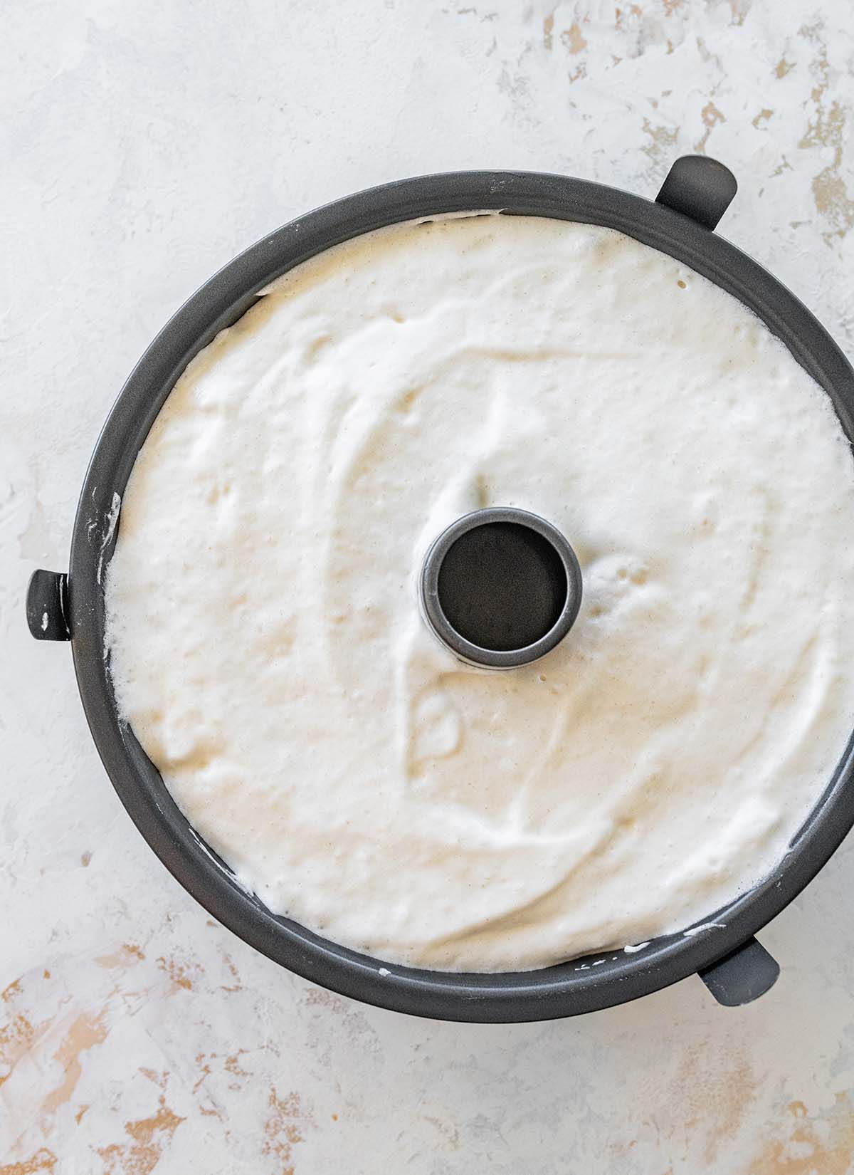 angel food cake batter in a tube pan.