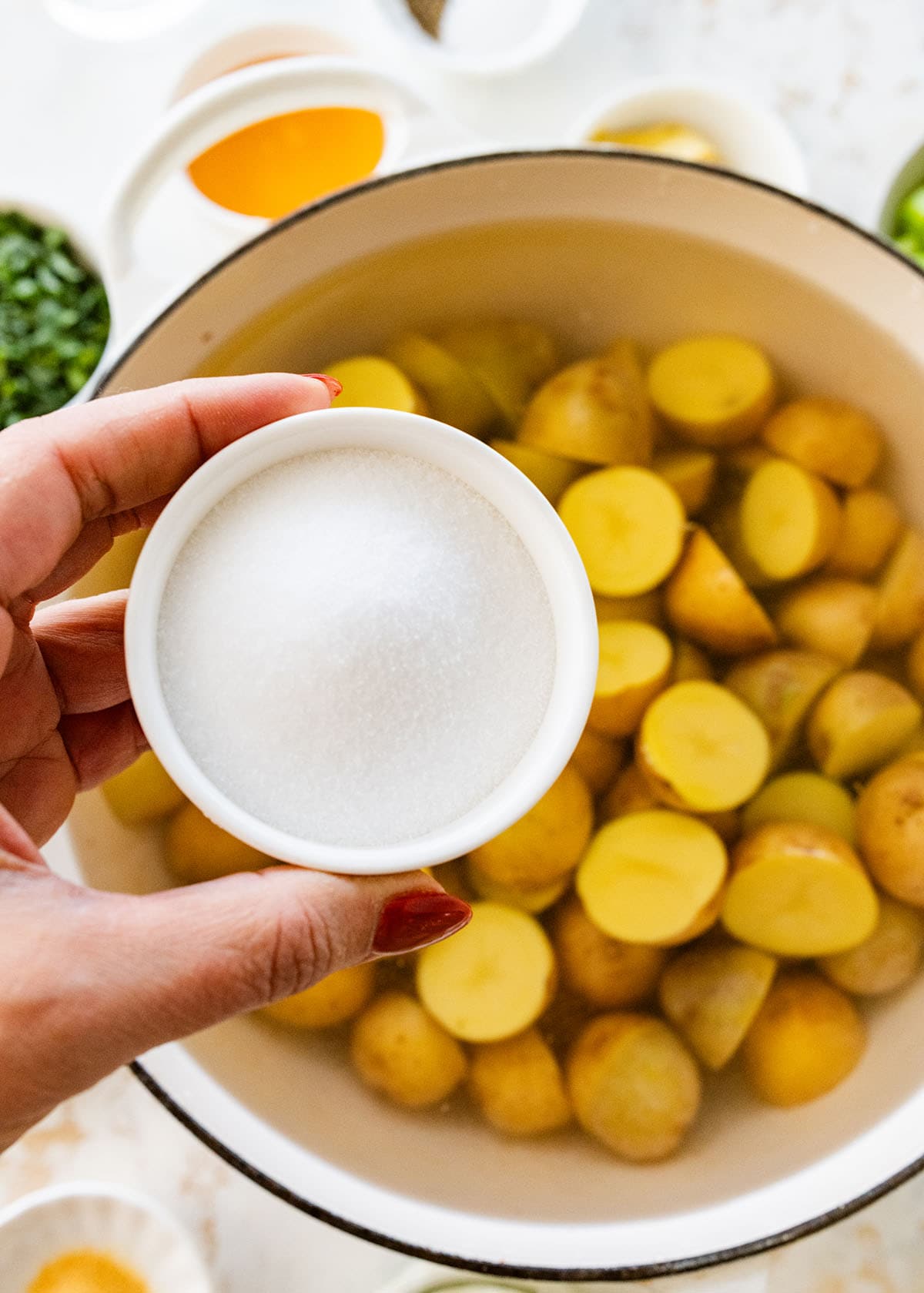 boiling potatoes with salt in an enameled Dutch oven.