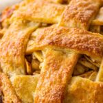 flaky layers in baked pastry lattice on top of an apple pie.