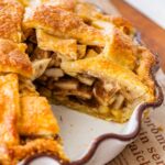 deep-dish, lattice-topped apple pie with a slice removed.