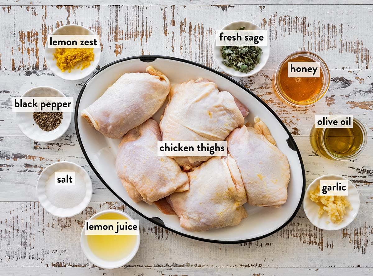 bowls of ingredients for lemon garlic chicken marinade with chicken thighs.