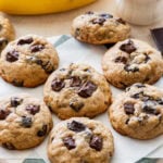 Banana bread cookies on a plate after baking, with more ingredients nearby.