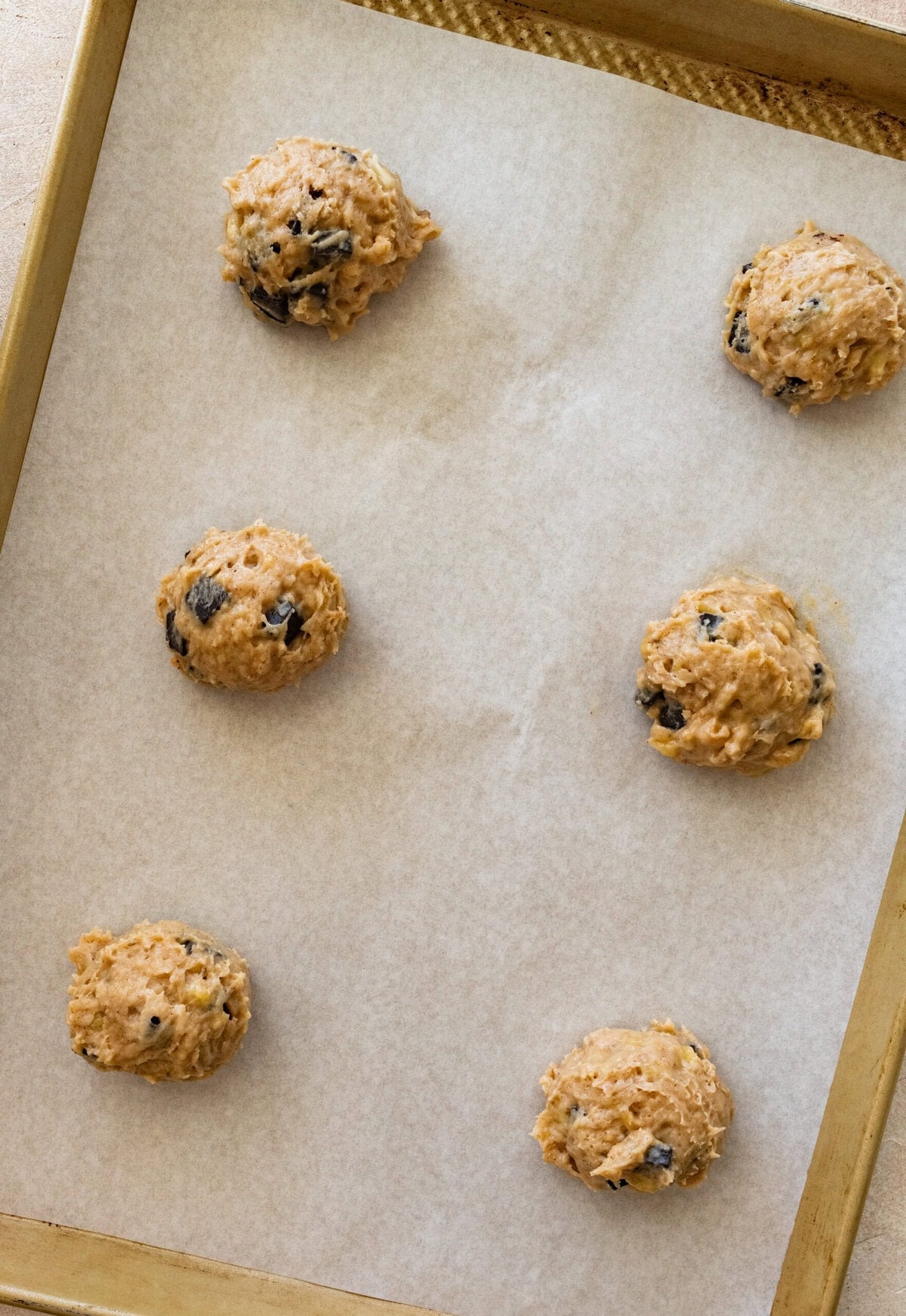 Cookie dough rolled into balls and placed on a baking sheet.