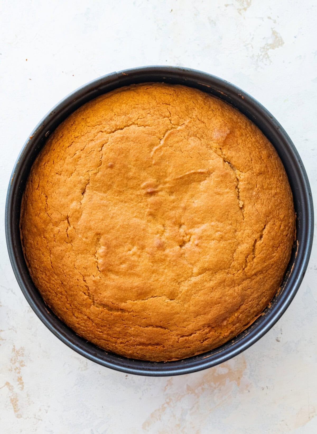 The cake in a cake pan after baking.
