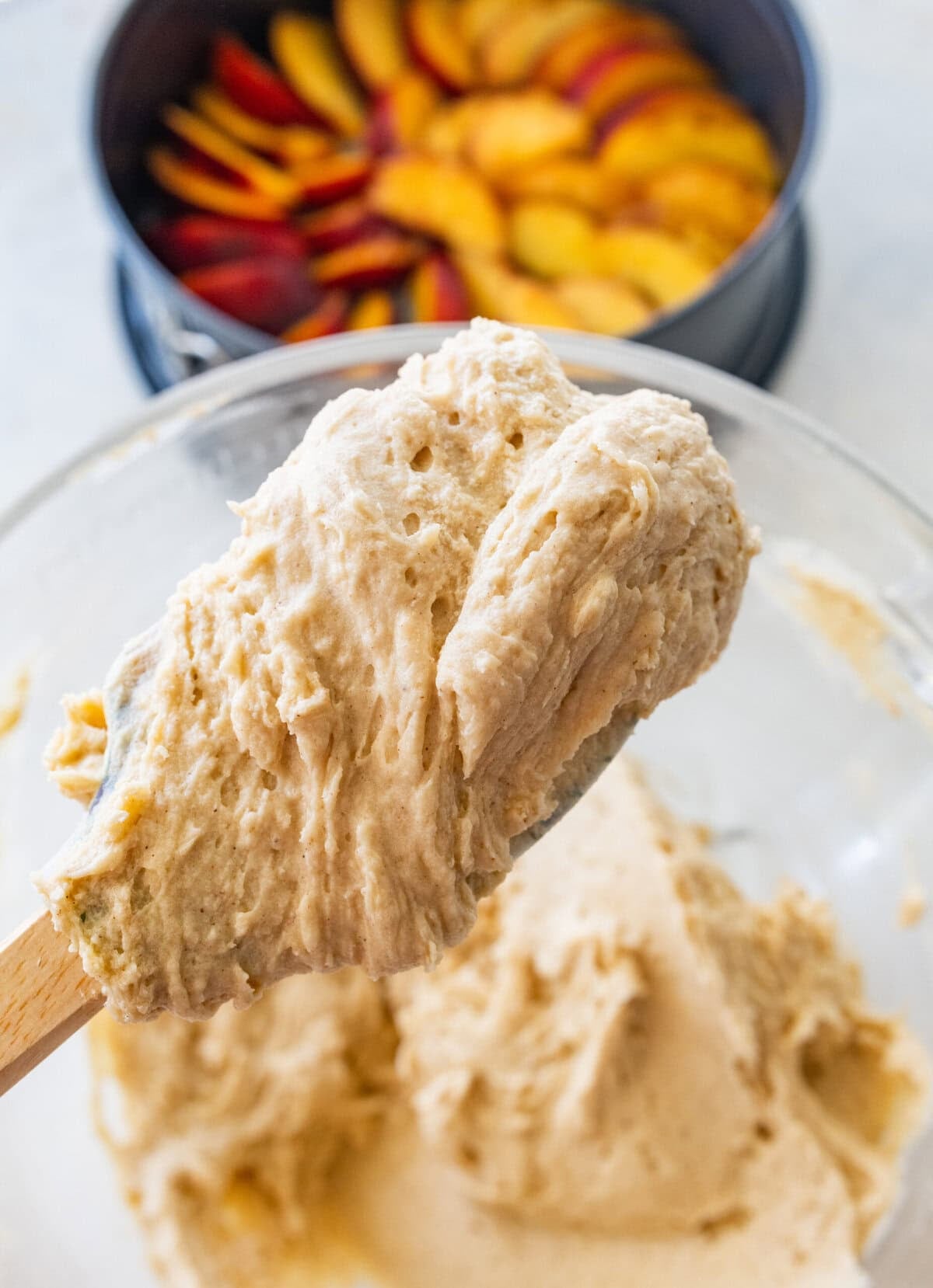 Fully combined batter in a bowl with a spatula holding up some.