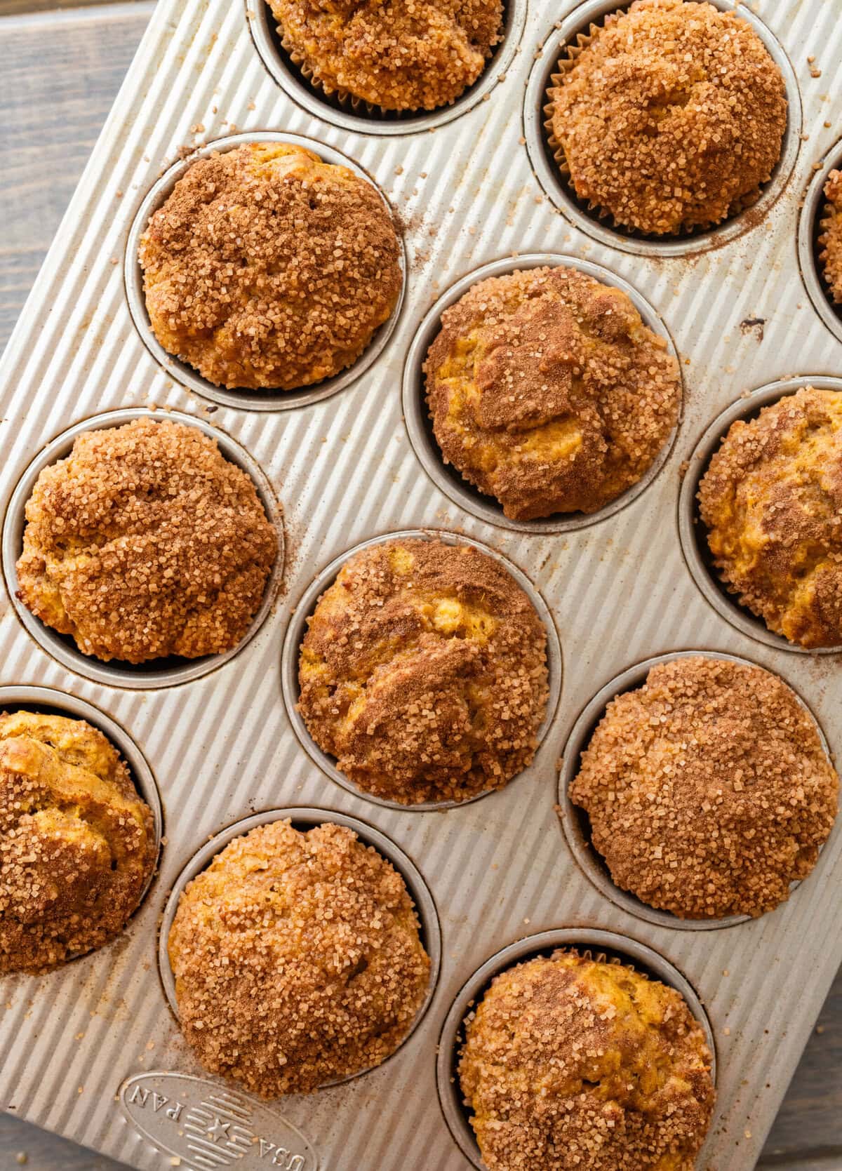 A muffin tin full of pumpkin banana muffins.