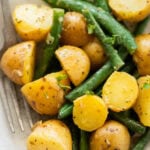 A bowl of green beans and potatoes.