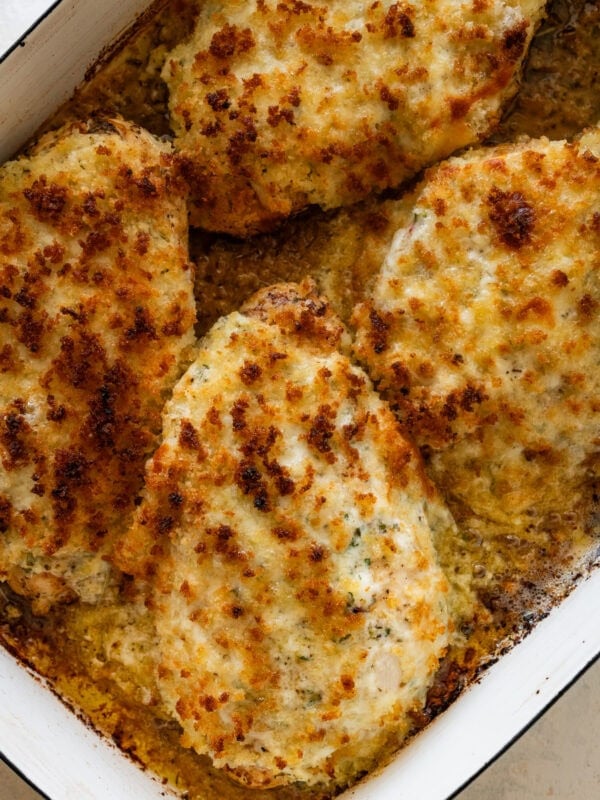 parmesan crusted chicken in a pan after baking and broiling.