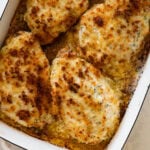 parmesan crusted chicken in a pan after baking and broiling.