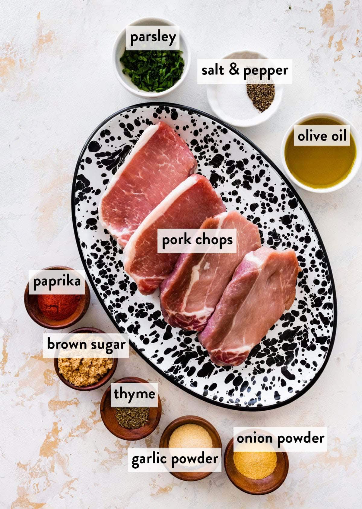 bowls and plates of ingredients for juicy baked pork chops.