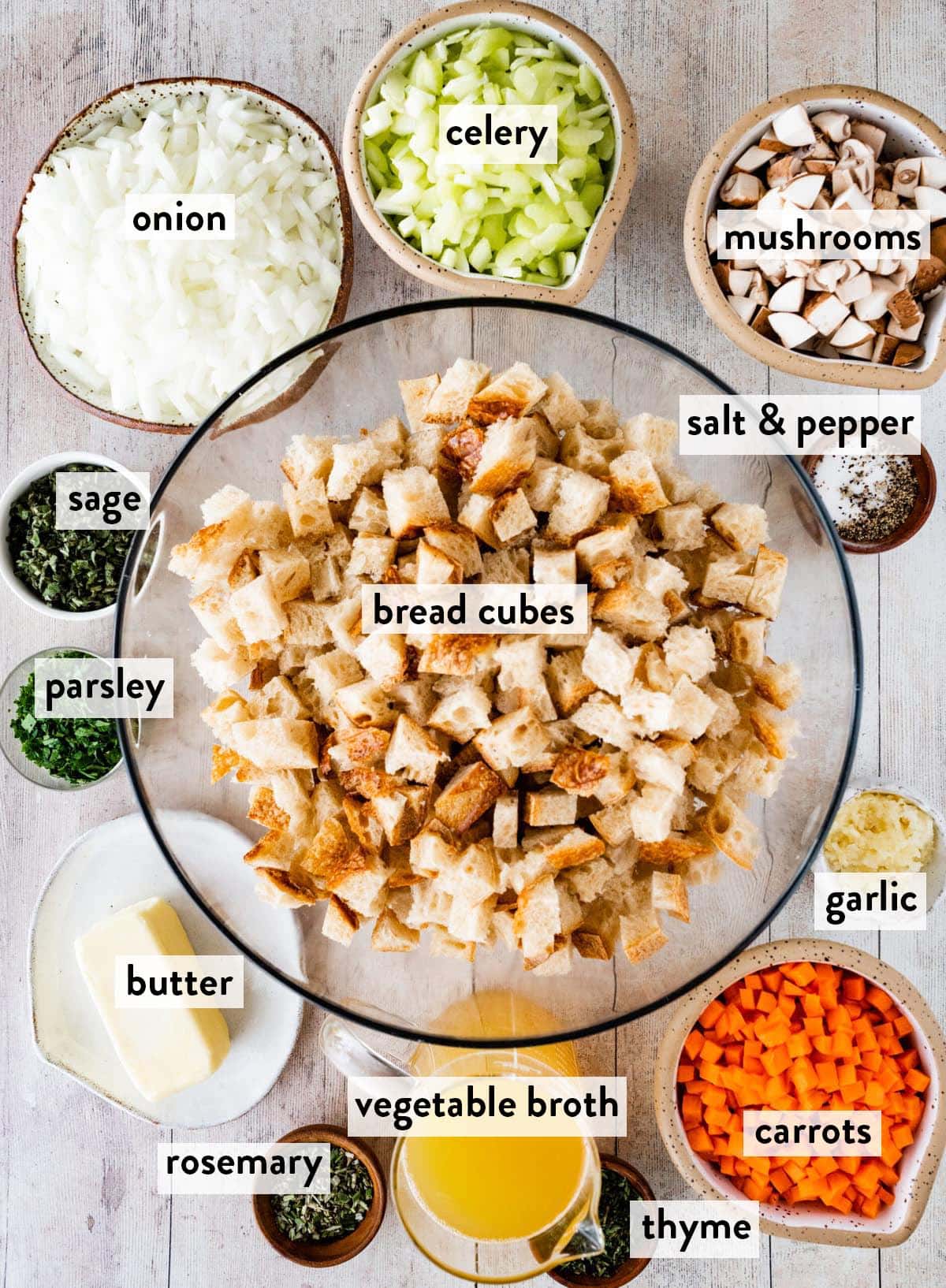 bowls of ingredients for vegetable stuffing on a marble countertop.