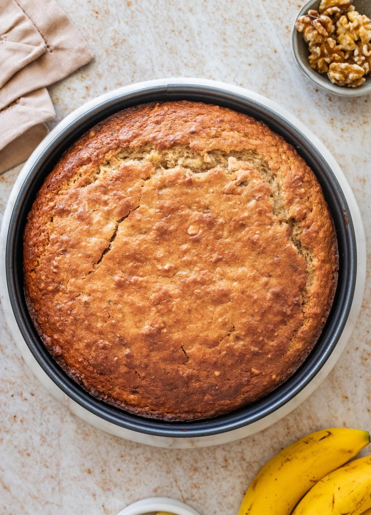 Banana nut cake in a cake pan after baking.