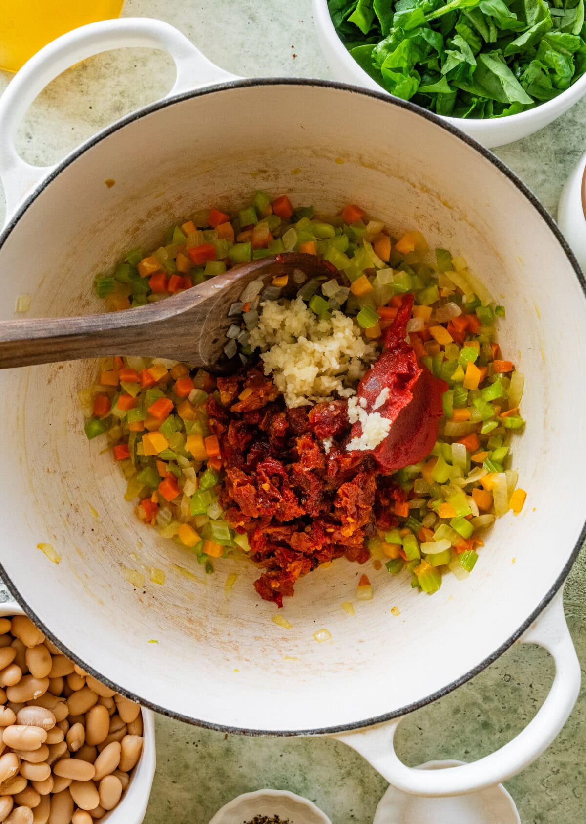 Olive oil and sun-dried tomato oil in a pot with the veggies and tomato paste added.
