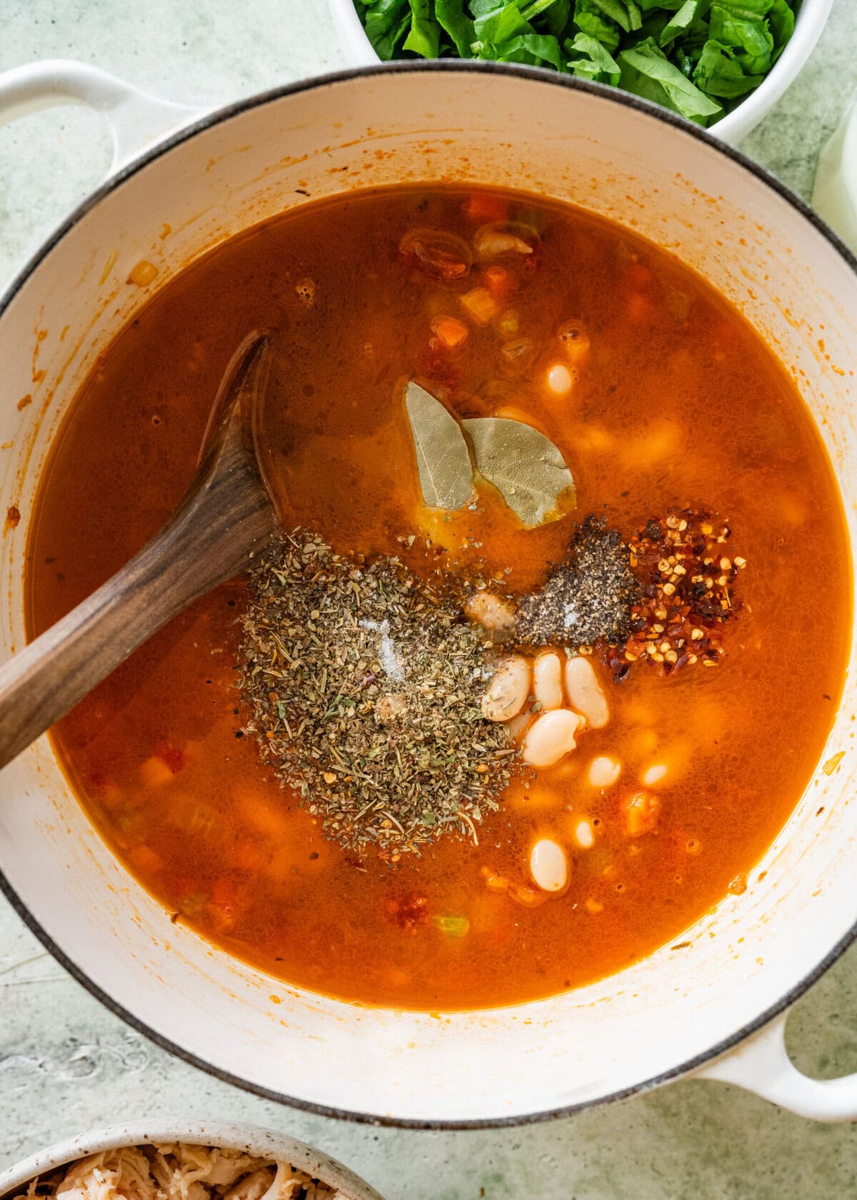 Seasonings and bay leaves added to the pot.