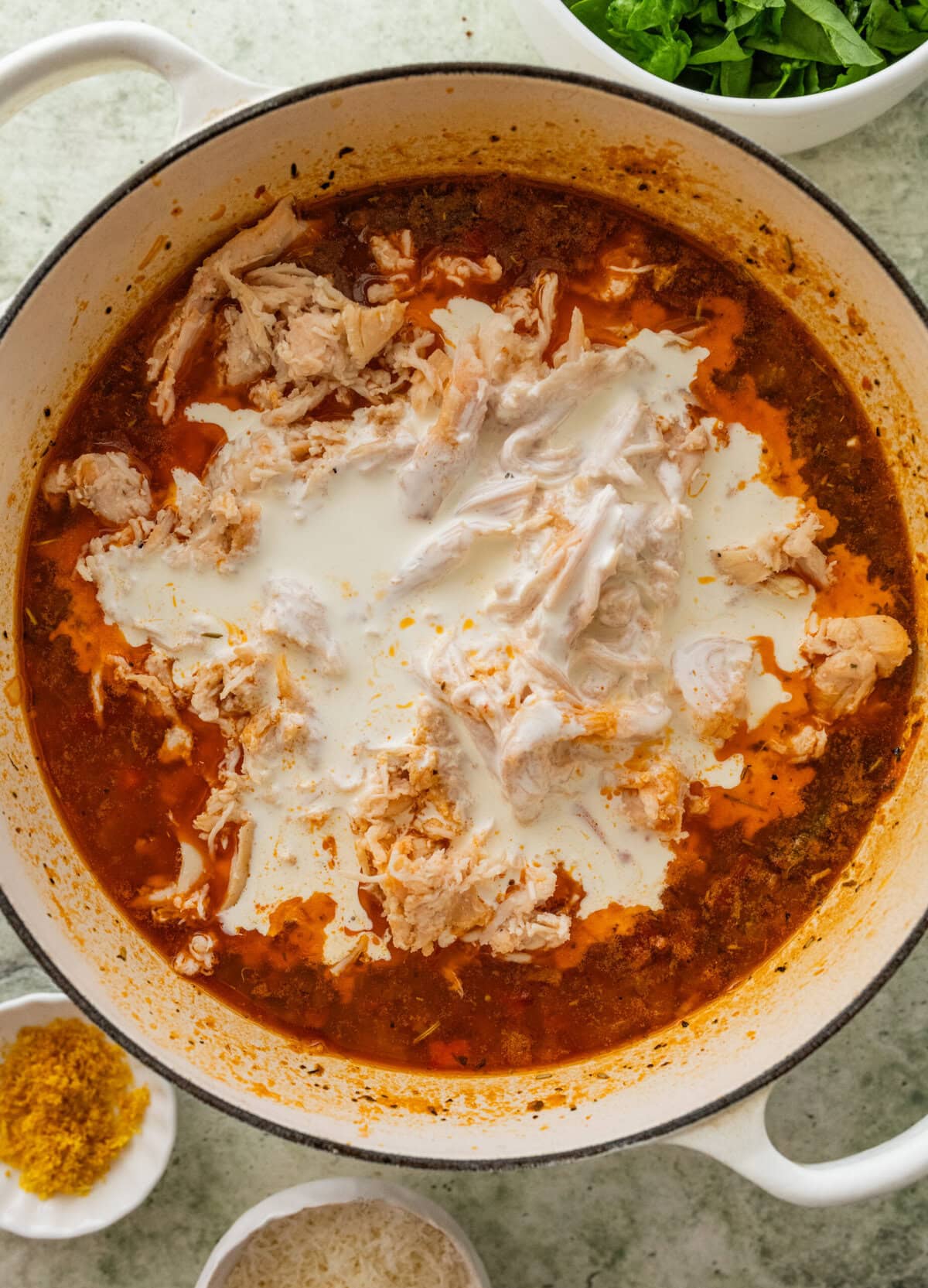Heavy cream and chicken added to the pot.