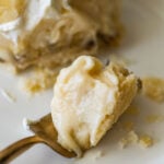 forkful of banana cream pie resting on a small plate.