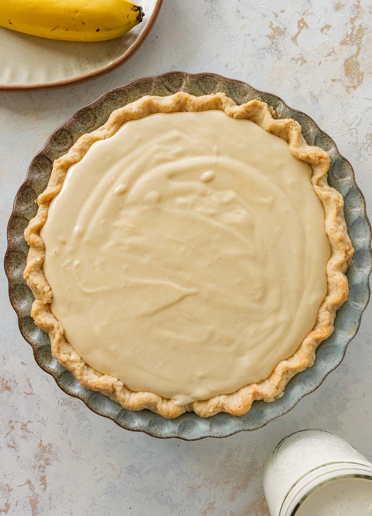 banana cream pie filling spread in the baked crust.