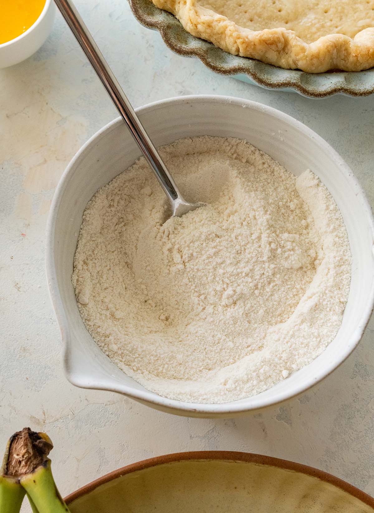 mixing flour and salt in a mixing bowl with a fork.