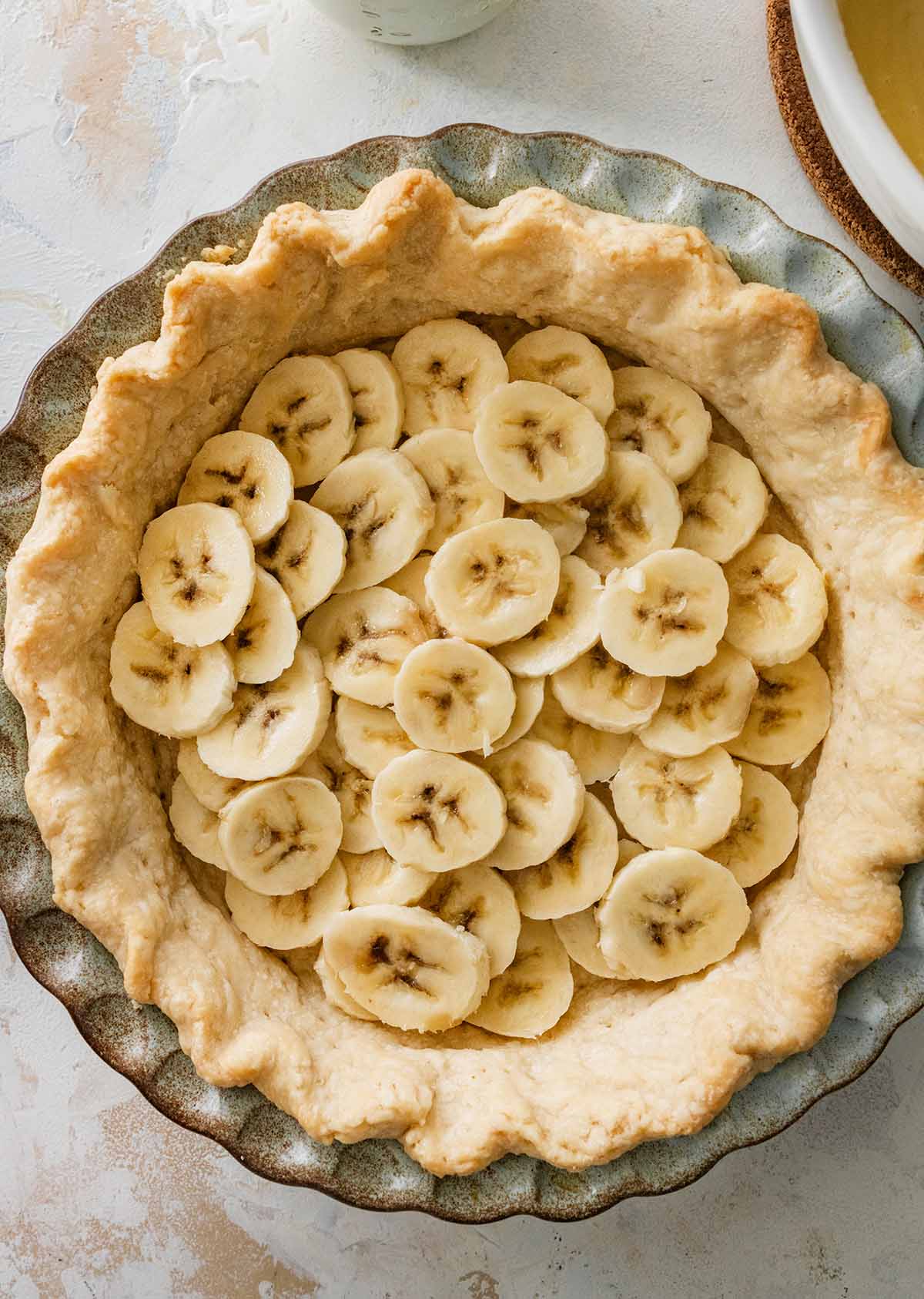 layering sliced bananas in a blind baked crust.