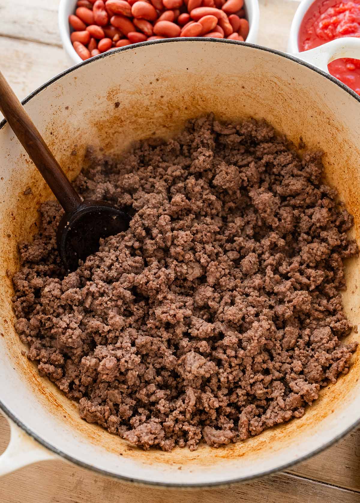 browned ground beef in an enamel Dutch oven.