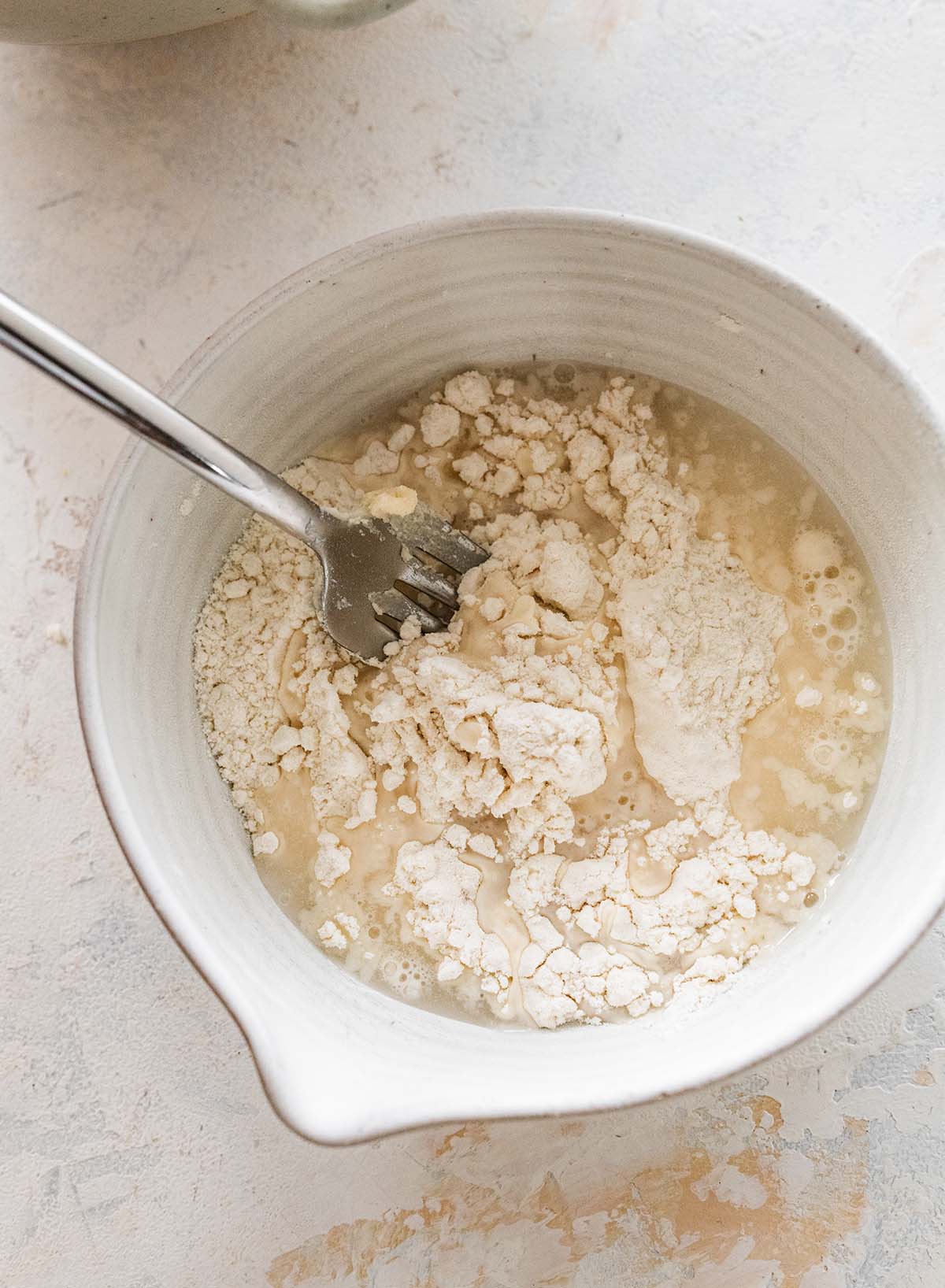 mixing cold water into flour.